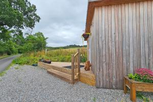a wooden deck with a teddy bear sitting on a building at The Drey Inchberry 