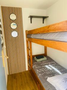 a couple of bunk beds in a room at Pavillon 4-6 couchages in Cap d'Agde