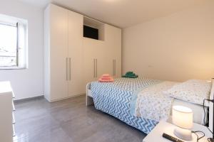 a bedroom with a bed and a desk with a laptop at Casa Gigi in Vercana