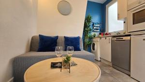 a living room with a table and two wine glasses at Appartement RENOVE EN PLEIN COEUR DE PARIS SUR L'ILE SAINT LOUIS ! in Paris +27 photos
