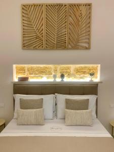 a bed with white pillows in a bedroom at Zisa Suite 2 in Palermo +22 photos