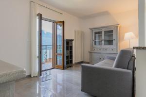 a living room with a couch and a sliding glass door at Casa Gigi in Vercana