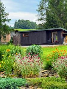 a garden with flowers in front of a building at Beautiful 1 bedroom village house among fields 