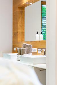 a bathroom with a sink and a mirror at Alpenloft 204, NEU ab 2025 in Forstau