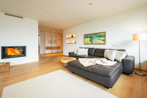 a living room with a couch and a fireplace at Alpenloft 204, NEU ab 2025 in Forstau +29 photos