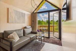 a living room with a couch and a large window at Gold LUX in Kuldīga