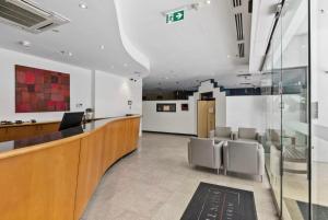 a waiting room with chairs and a reception desk at Retreat Horizons - Spacious Perth CBD 1BR in Perth