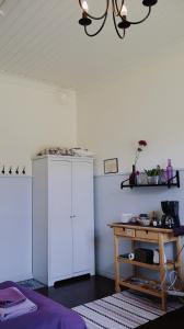 a room with a white cabinet and a table at Huoneistohotelli Marja in Mikkeli +66 photos