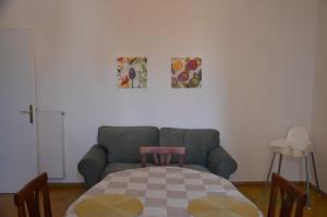 a living room with a couch and a table at Casa Mila in Marina di Carrara