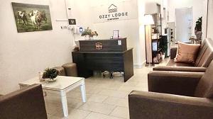 a living room with a piano and a couch at Ozzy Lodge Semporna in Semporna