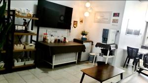 a living room with a flat screen tv and a piano at Ozzy Lodge Semporna in Semporna