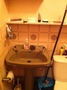 a small bathroom with a sink and a toilet at 48 Harper Road Beckton Shared in East Ham