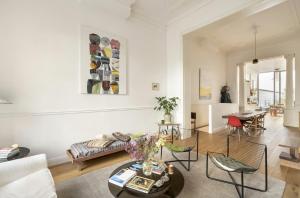 a living room with a couch and a table at Cozy Room with Garden in Brussels