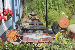 a group of tables on a balcony with flowers at Hochgallinger Hof - Der Reiterhof für Groß und Klein in Siegsdorf