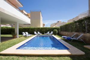 a swimming pool in the backyard of a house at Cabot Villa Sa Sini in Port de Pollensa