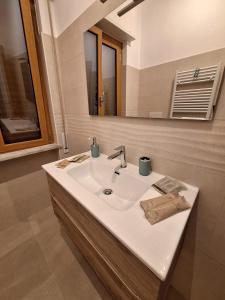 a bathroom with a white sink and a mirror at La Risacca in Pietra Ligure +27 photos