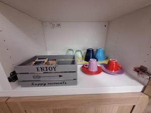 a shelf with boxes and cups on top of it at La Risacca in Pietra Ligure