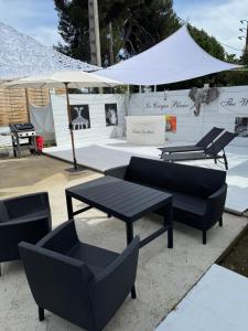 a group of chairs and tables under a white tent at Maison avec piscine in Antibes