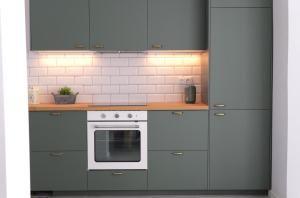 a kitchen with gray cabinets and a white oven at Church view house in Lagos