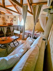 a living room with two beds and a table at Oskar Sunny House - Adults Only in Gabonjin