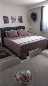 Un dormitorio con una cama grande y una mesa con sillas. en Tiny home at the castle, en Shkodër
