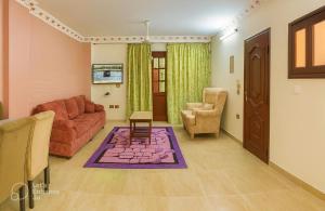 a living room with a couch and a chair at Cairo Airport Retreat - Stylish Stay, Obour city -First district in Obour +7 photos