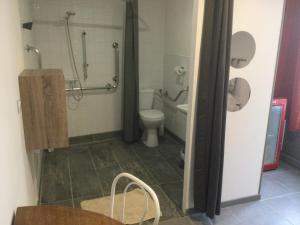 a bathroom with a toilet and a shower at Castel&Letti in Agde