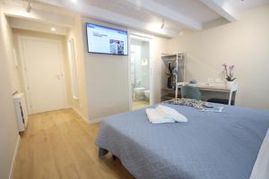 a bedroom with a bed with a tv on the wall at Photomusic Boutique Rooms in Senigallia