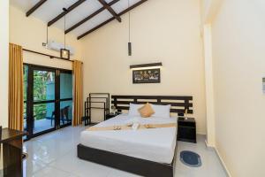 a bedroom with a bed in a room at Heaven Breeze Hotel Ahangama in Ahangama +71 photos