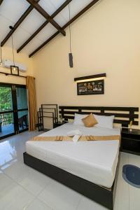 a bedroom with a large bed in a room at Heaven Breeze Hotel Ahangama in Ahangama