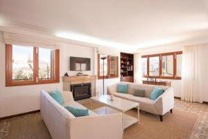a living room with two couches and a fireplace at Cabot Villa Sa Sini in Port de Pollensa