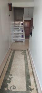 a hallway with a rug on the floor of a store at Tatawi in Ouai Hourri