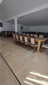 a room with a long wooden table and chairs at Casa Vlad-Alex in Săpânța