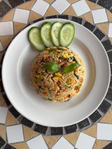 a plate of food with a sandwich and cucumbers at Pai Kiang Fa in Pai +55 photos