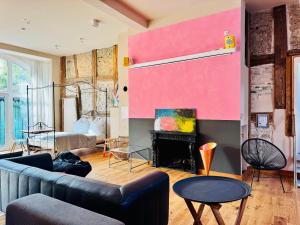 a living room with a couch and a fireplace at Villa Schloss Rimsingen Fine Apartments in Breisach am Rhein