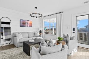 a living room with a couch and chairs and a table at The Morgan in Gulf Shores