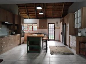 a kitchen with wooden cabinets and a island in it at The Lazy Daze in Vaal Marina