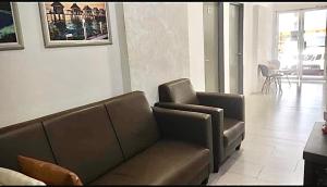 a living room with a couch and a table at Ozzy Lodge Semporna in Semporna