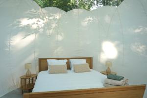 a bedroom with a white bed with two lamps at L'étape en forêt in Saint-Sever-Calvados +44 photos