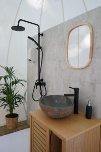 a bathroom with a bowl sink on a wooden counter at L'étape en forêt in Saint-Sever-Calvados