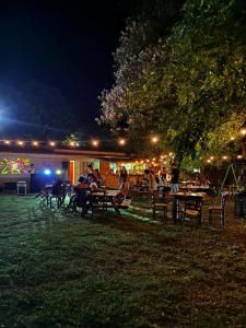 people sitting on benches in a park at night at Agriturismo Curatola in Spilinga