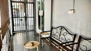 a bench in a room with a window and a table at Ozzy Lodge Semporna in Semporna