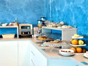 a kitchen with a bunch of food on a counter at Serpa Hotel in Anzio