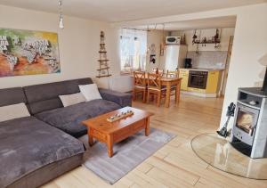 a living room with a couch and a table at Ferienhaus Polly - Keine Monteure in Rabenau