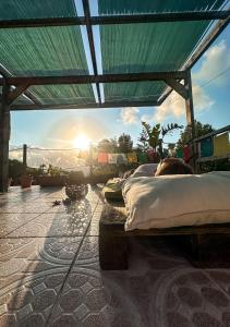 a group of beds on a patio with the sun setting at Pilgrims Rest - Vila Nova de Cerveira - Hostel - Albergue - AL in Vila Nova de Cerveira