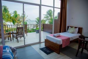 a bedroom with a bed and a view of the ocean at Villa Ocean Dew in Galle +85 photos