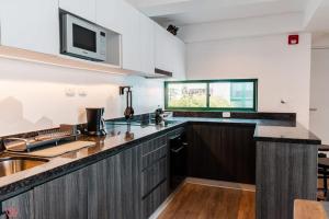 a kitchen with a sink and a counter top at Delightful 2BR Amazing View in Barranco in Lima