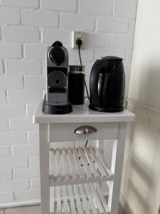 a table with a coffee maker and a coffeemaker on it at Mekxy in Herkingen