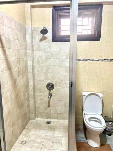 a bathroom with a toilet and a shower at Florence Ville in Cape Coast