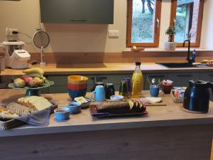 a table with food on a counter in a kitchen at Au cordonnier in Troncens